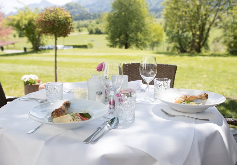 Table set on the terrace of the club restaurant overlooking the golf course