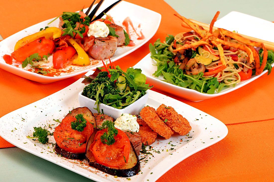 Several artfully plated dishes with a variety of starters
