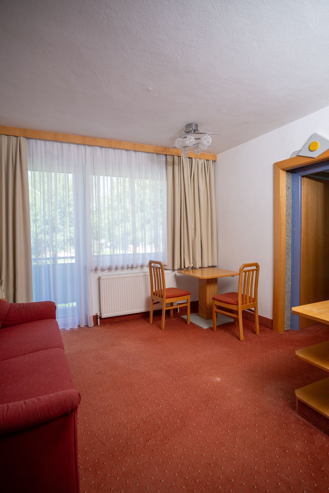 Dining spot in the living area of the Type A suite with balcony door