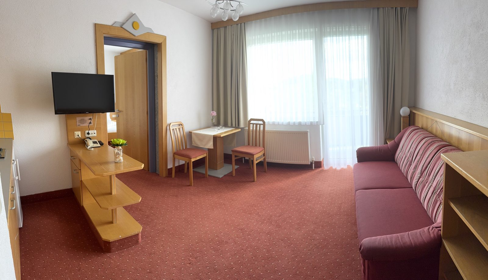 Living area of Suite Typ A with sofa bed and terrace door